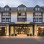 Eingang des beleuchteten Land & Golf Hotels Stromberg am Abend